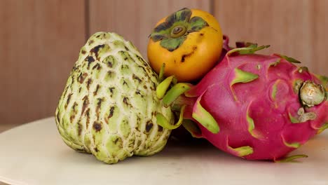 cherimoya, persimmon, and dragon fruit arrangement