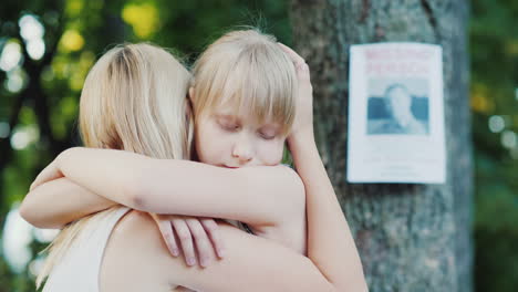 Woman-Hugs-The-Child-Against-The-Background-Of-A-Man-Missing-Ads