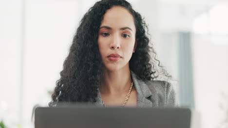 Serious,-business-woman-working-on-laptop-in-job