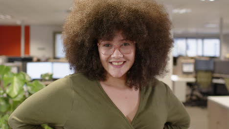 portrait of smiling casual biracial businesswoman in office, slow motion with copy space