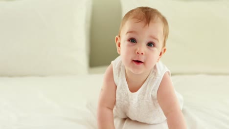 Cute-smiling-baby-girl-on-bed