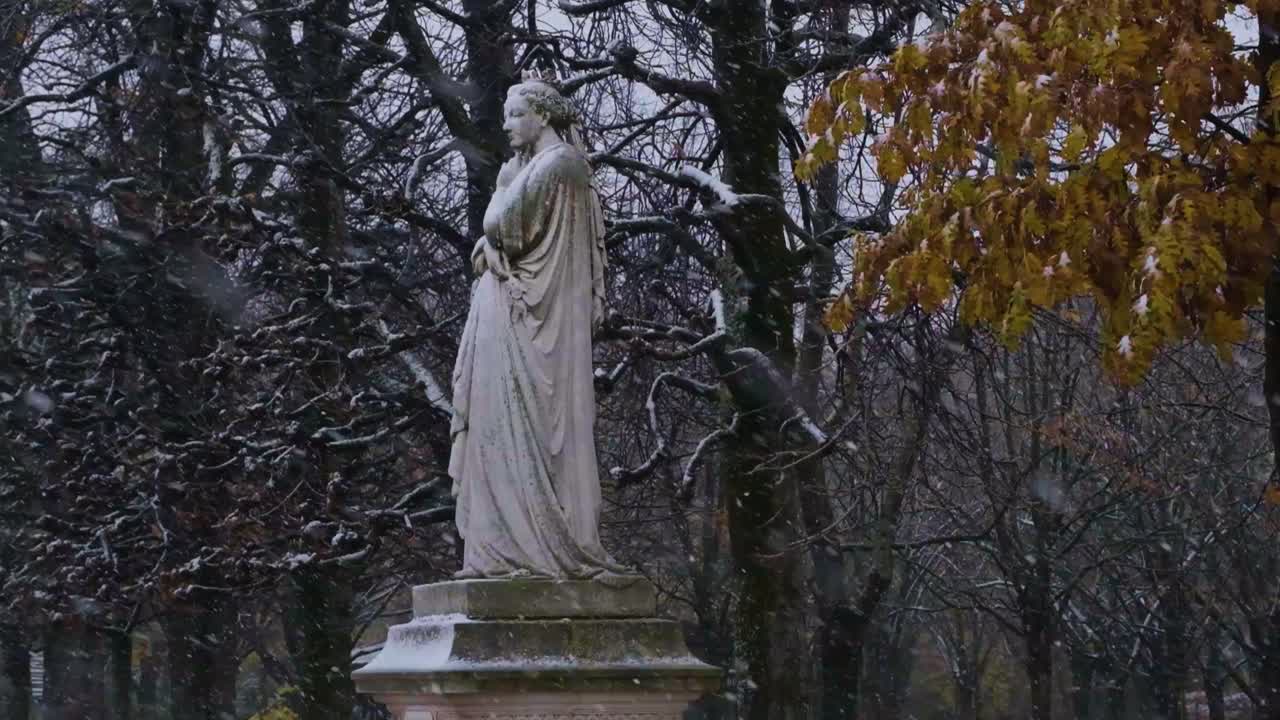 Slow-motion shot of snow Falling on Statue in Luxembourg Gardens, Paris