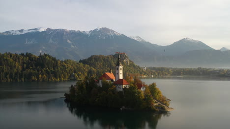 epic cinematic drone footage of the pilgrimage church of the assumption of mary, slovenia during the golden hour