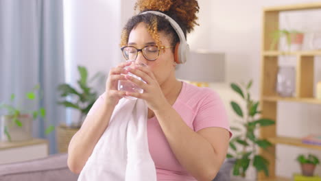 headphones, towel and woman drinking water