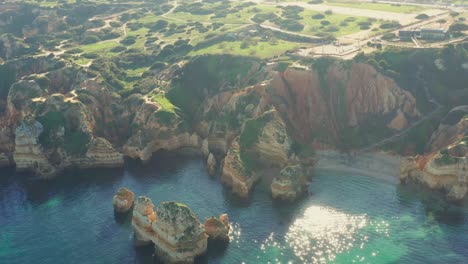 tracking aerial shot revealing the crystal clear waters of the algarve region in lagos, portugal