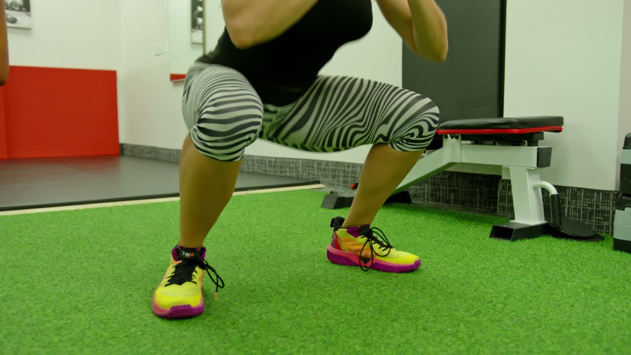 Female athlete training at exerciser in health club