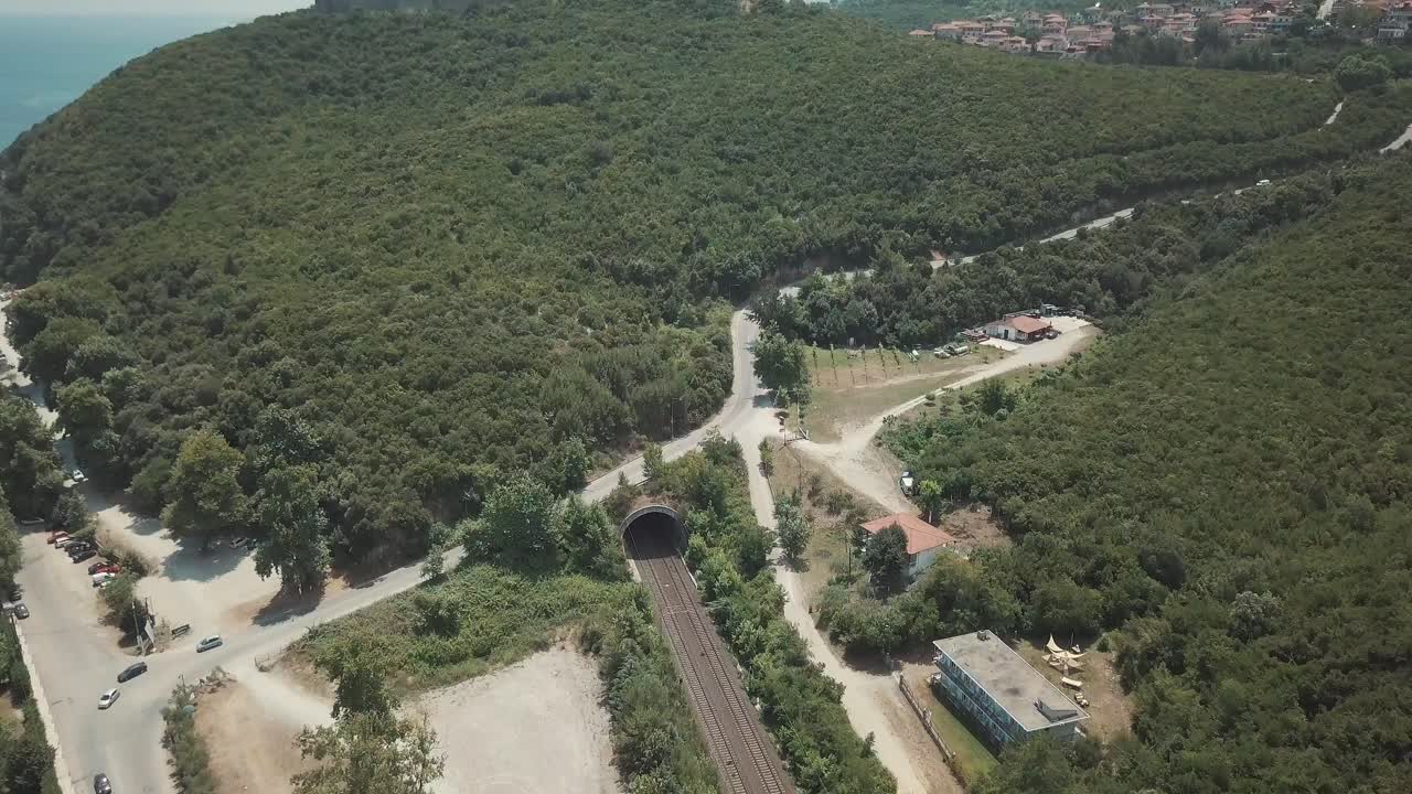 Aerial view of a forest road and railroad tunnel