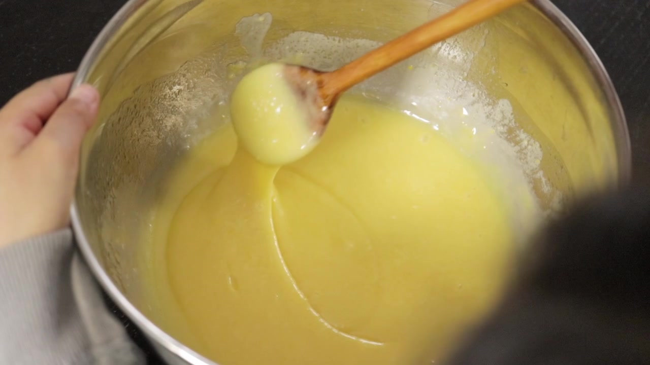 Children making a cake at home, close-up soft focus, slow motion