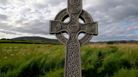 ancient celtic cross in a rural irish landscape