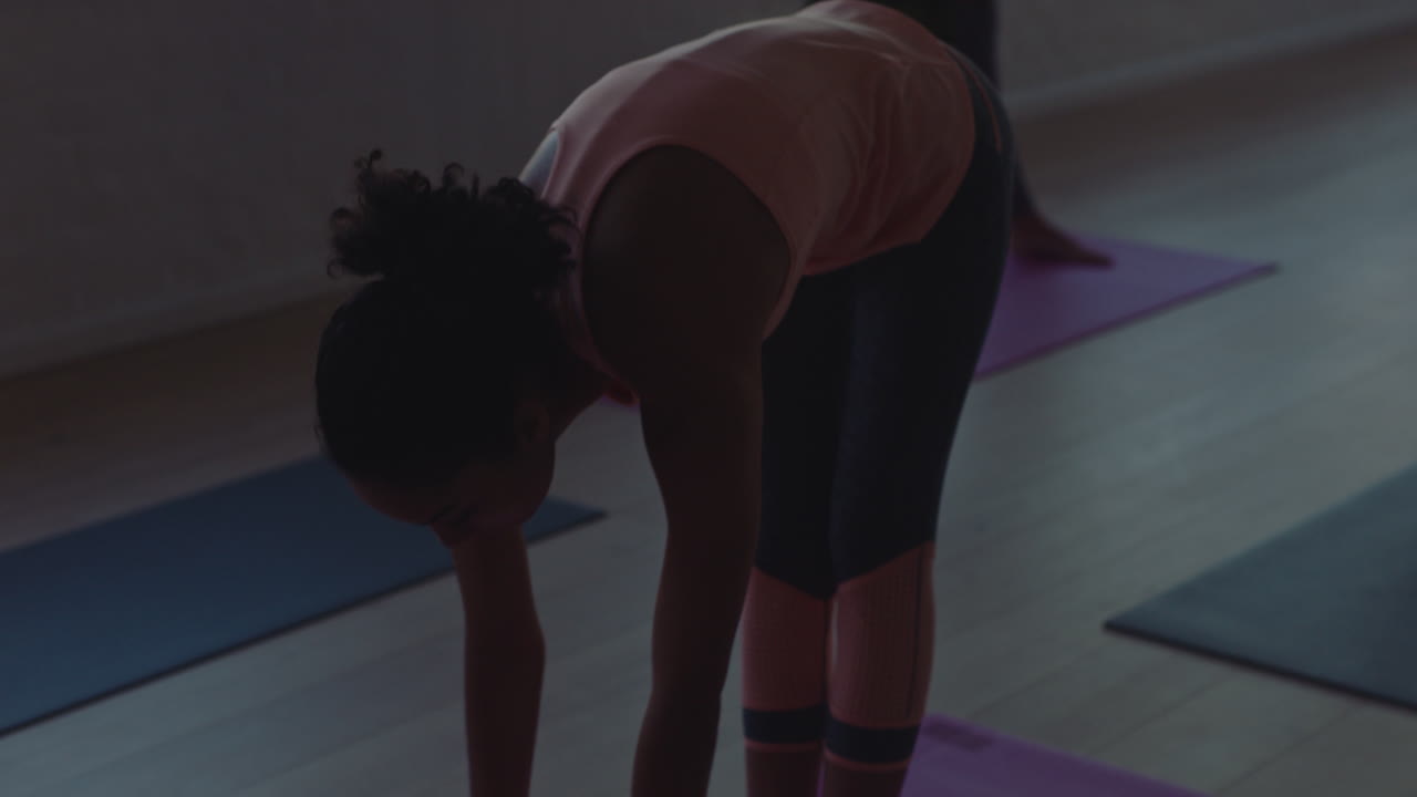 yoga class young mixed race woman stretching body on exercise mat preparing for ealy morning workout getting ready in fitness studio at sunrise