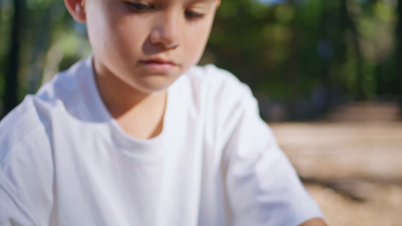 Hands touching bicycle wheel at sunny alley closeup. Unknown man helping to boy