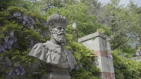 bust of a king in a garden setting