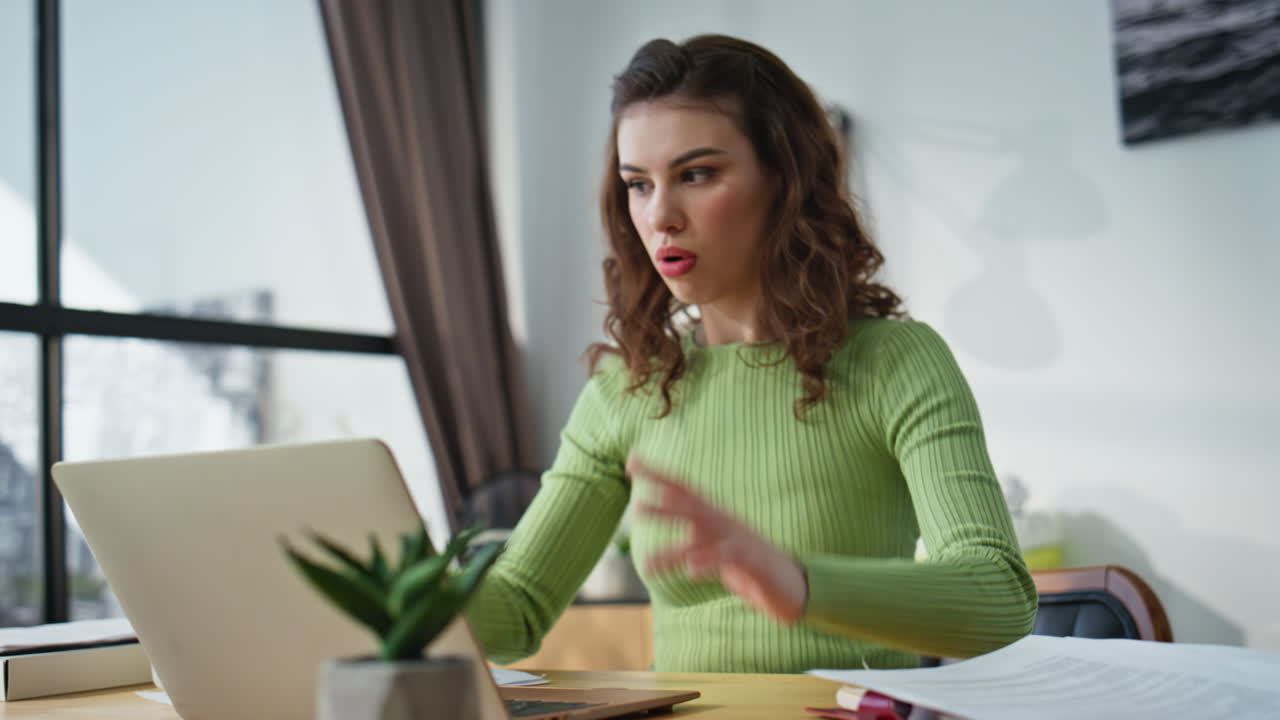 Serious businesswoman holding documents working computer at cabinet closeup