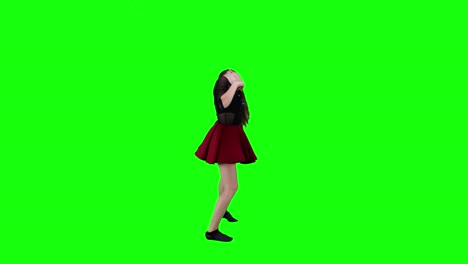 side view of a professional female dancer dancing in front of a green screen