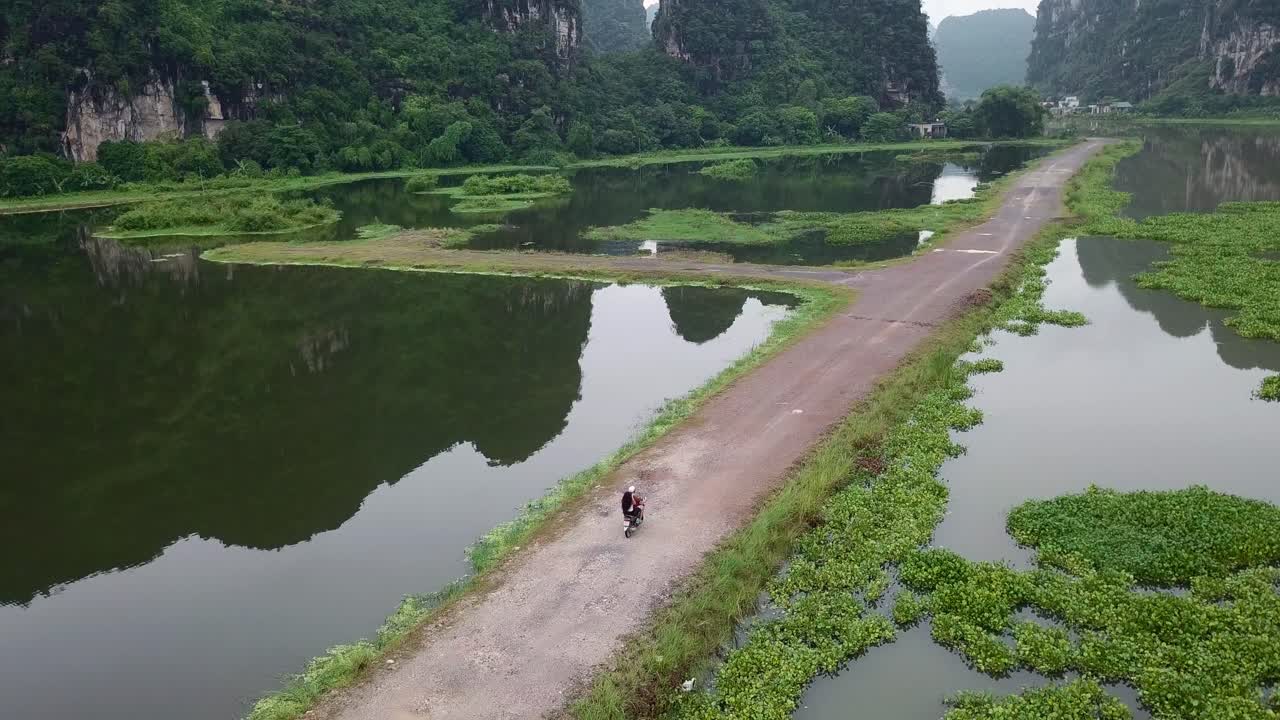 Epic footage of a picturesque landscape in Vietnam in the front is a motorbike driving
