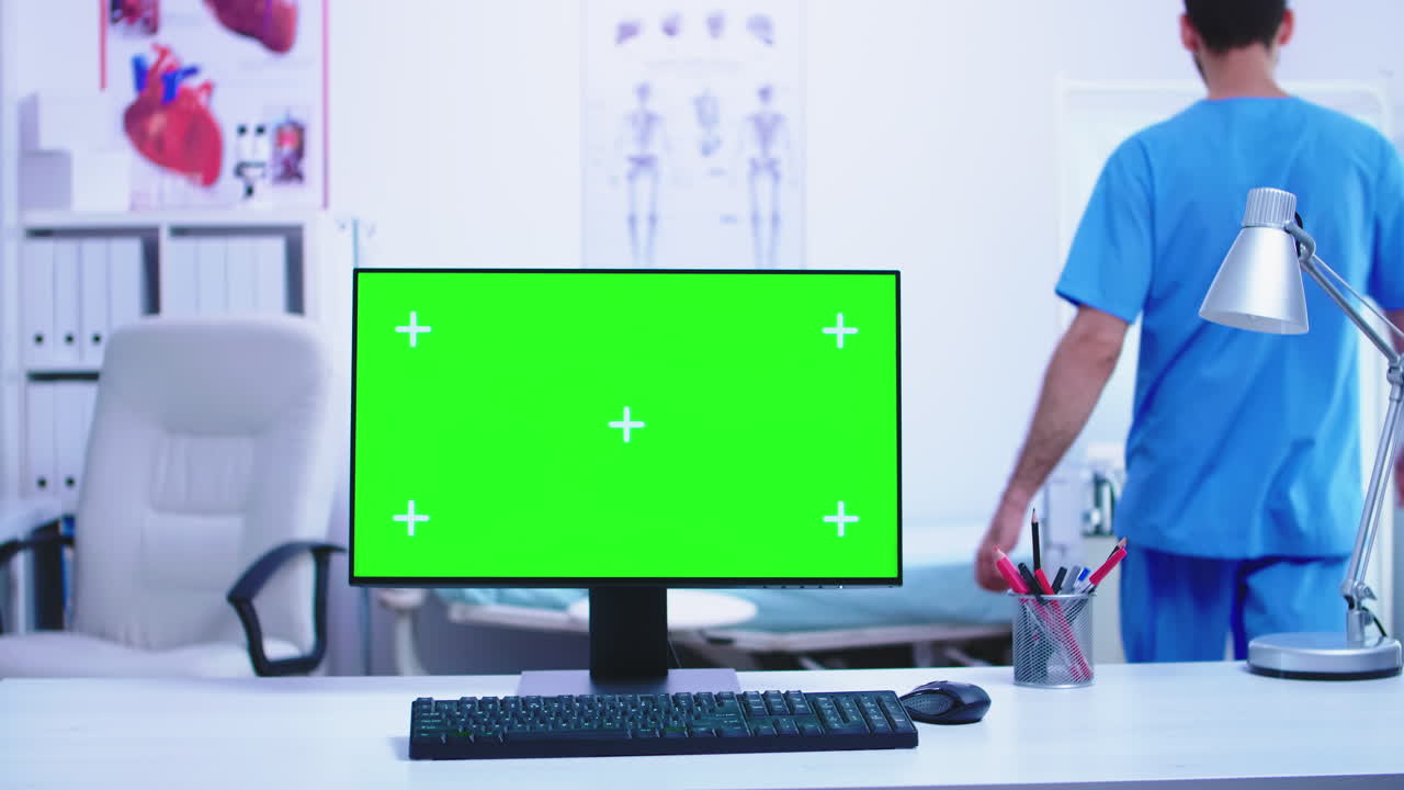Dolly shot of computer with green screen