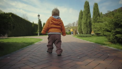 little kid walking on grass