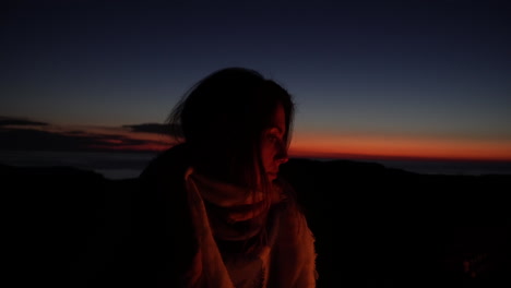 Young-girl-alone-in-dark-woods-alone-by-campfire