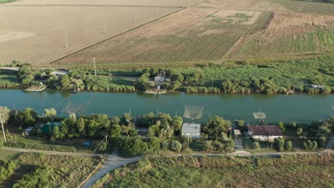 Aerial-view-of-fishing-huts-in-the-river,-Lido-di-Dante,-Fiumi-Uniti,-Ravenna-near-Comacchio-valley