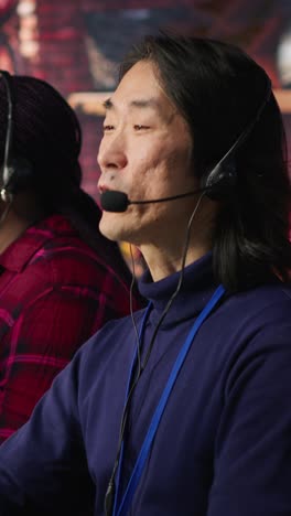 vertical video multiethnic team of call center agents answering clients