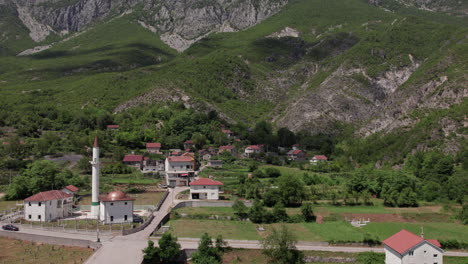 aerial view of a small mountain village with a mosque