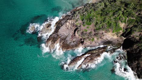 foamy crashing waves at the rugged shores of paradise caves in noosa heads, queensland, australia