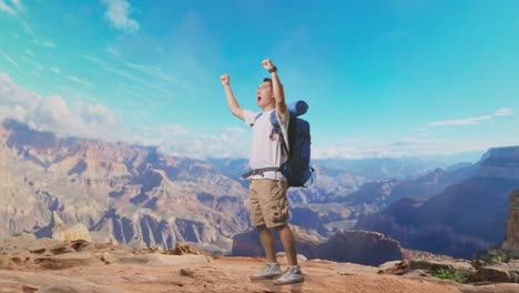 full body side view of asian male hiker with mountaineering backpack screaming goal celebrating the success while traveling at the top of mountain