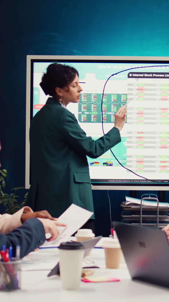 Businesswoman Presenting Financial Data on Interactive Screen in Office