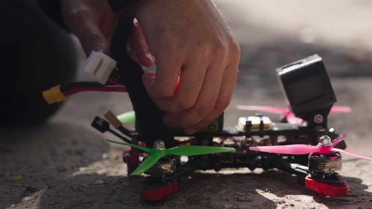 Close Up of Hands Connecting Battery to FPV Racing Drone