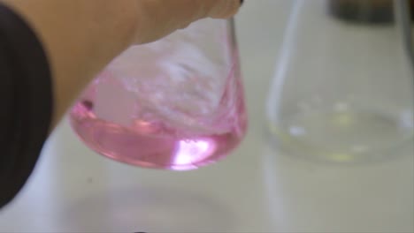 scientist pouring sample into beaker