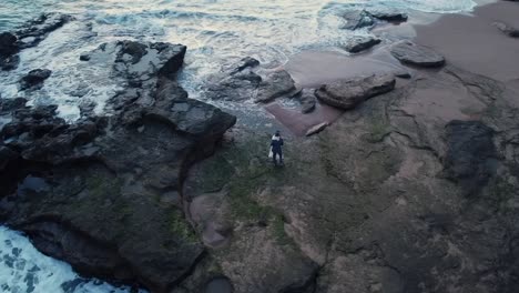 Bride-and-groom-dancing-on-rocky-coast