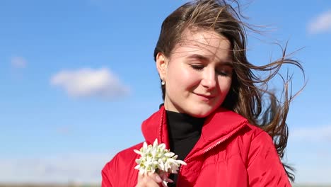 beautiful smiling brunette girl holding bouquet of snowdrops first spring flowers beautiful smiling brunette girl holding bouquet of snowdrops first spring flowers girl holding flowers and smiling to camera spring flowers