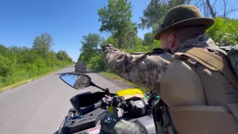 ukrainian soldier rides an atv on the frontlines of war in donbas, ukraine