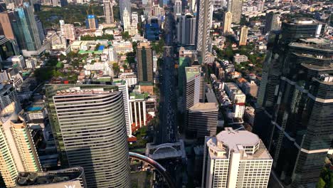 bts skytrain in silom area in bangkok between skyscrapers in the business district