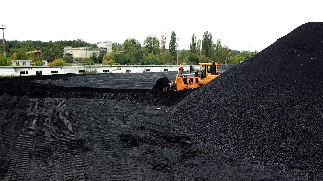 Coal mining at an open pit. Fossil fuel industry. Environmental challenge. Aerial view.
