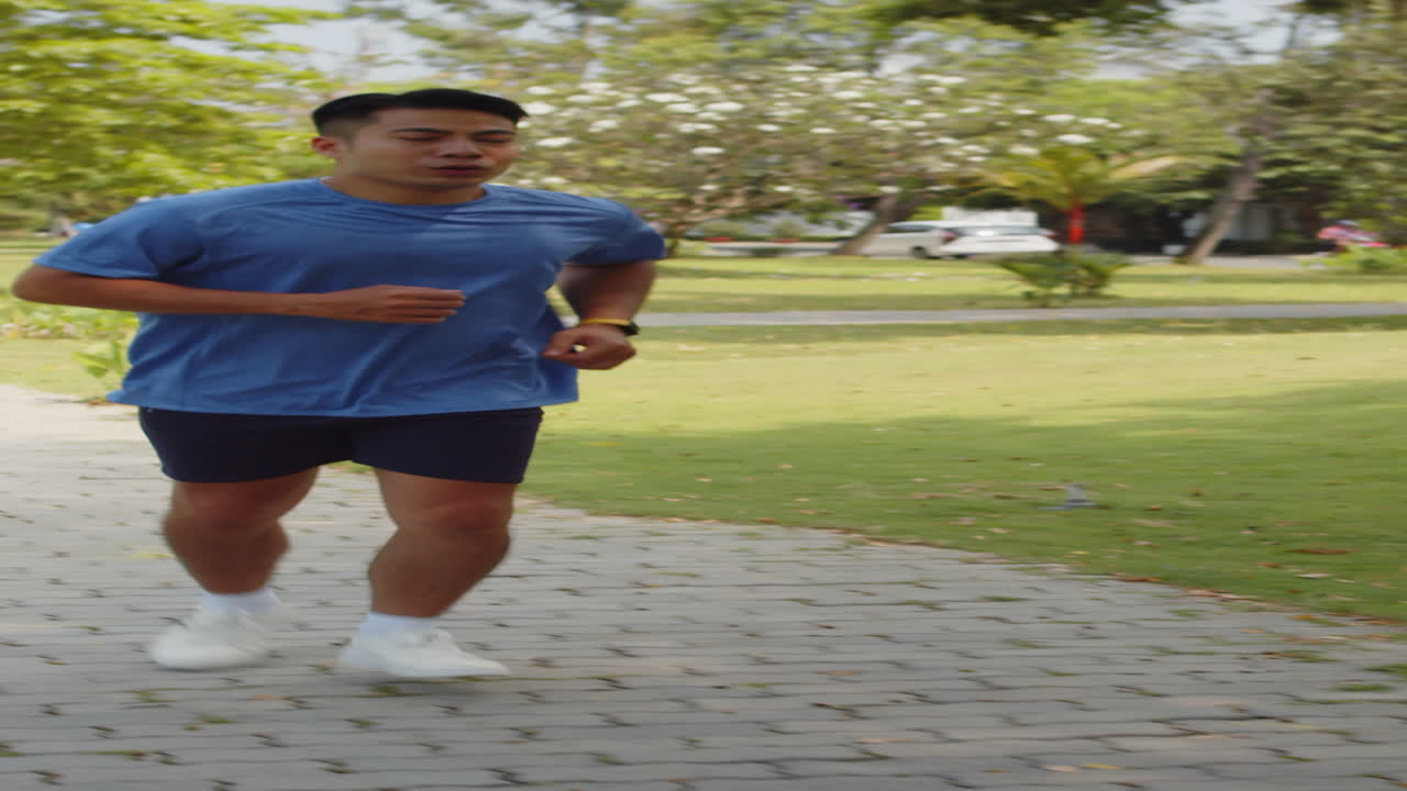 Vertical of Asian Athlete Jogging in Local Park