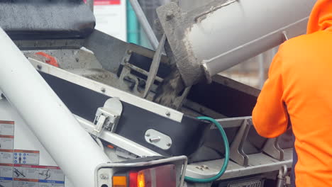 close up concrete transferred from cement truck to concrete pumping machine