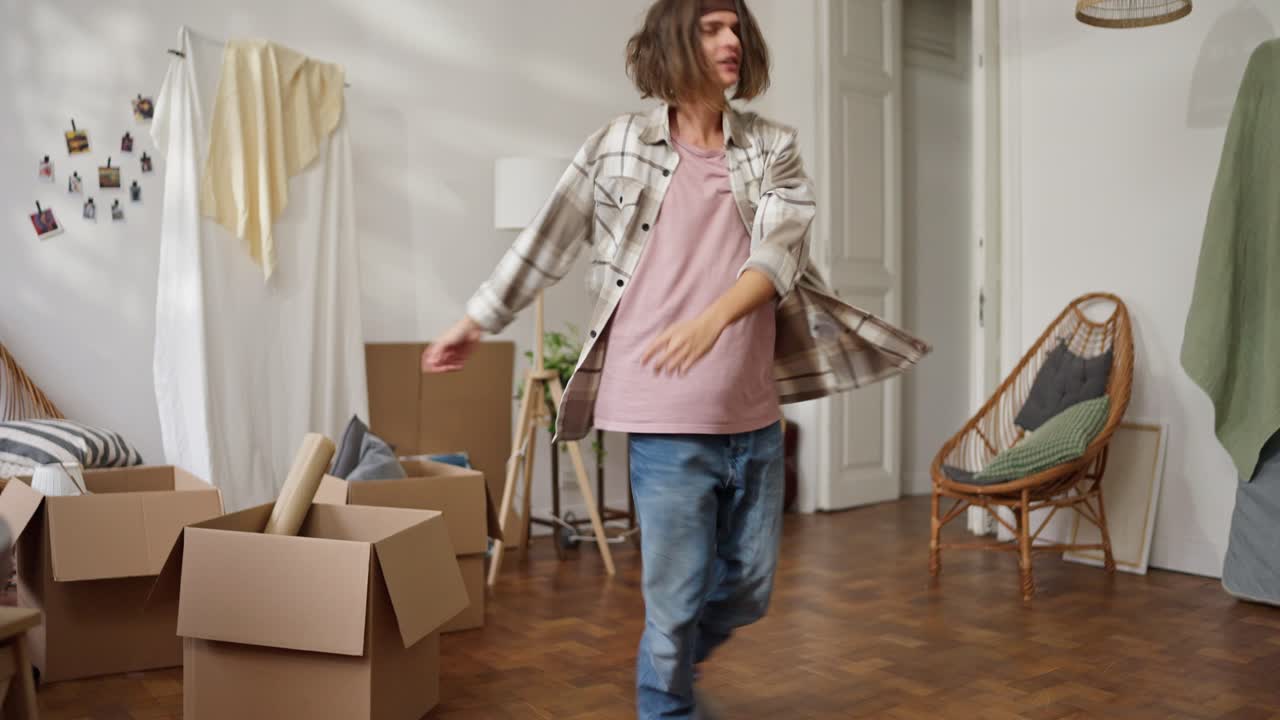Happy Man Dancing in His New Apartment During a Move