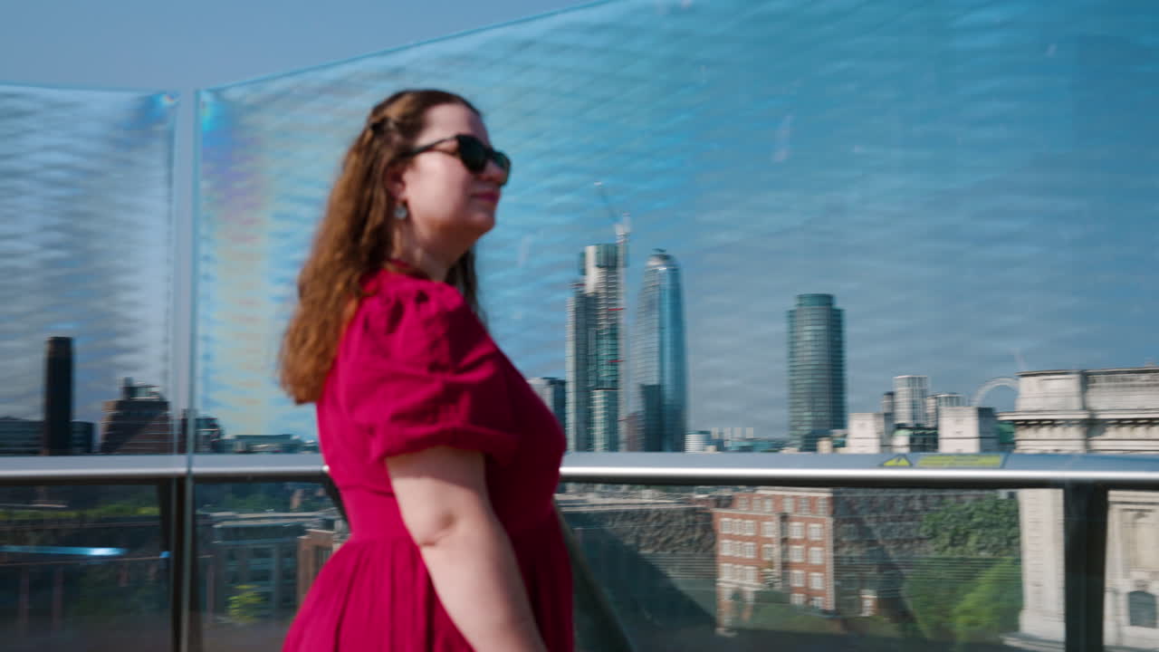 Mulher viajante no terraço do edifício olhando para a Catedral de São Paulo em Londres, Inglaterra, Reino Unido. Plano orbital em ângulo baixo.
