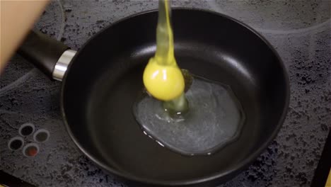 fried egg. raw egg on the frying pan in slow motion.