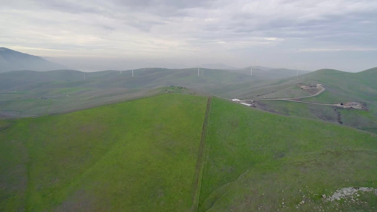 Forward Dolly of Distant Wind Turbines Engulfed in Smokey Mountain Mist