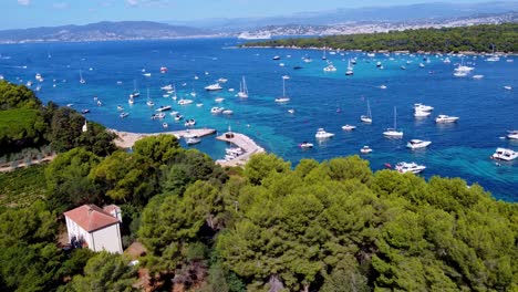 flying int the direction of the mediterranean sea, in saint honorat island part of the iles de lérins, next to cannes in south of france