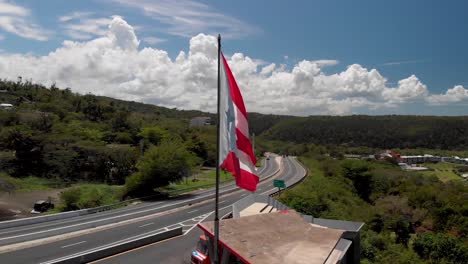 puerto rico flag waving with the beach behind.