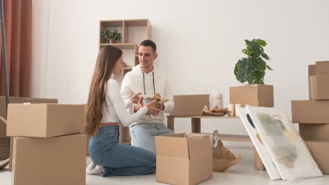 happy couple moving house packing their belongings and kissing