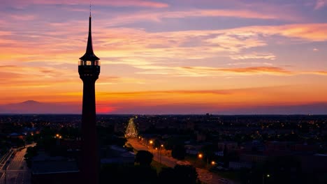 city lights gradually turning on as the sun sets below the horizon, creating a beautiful evening skyline