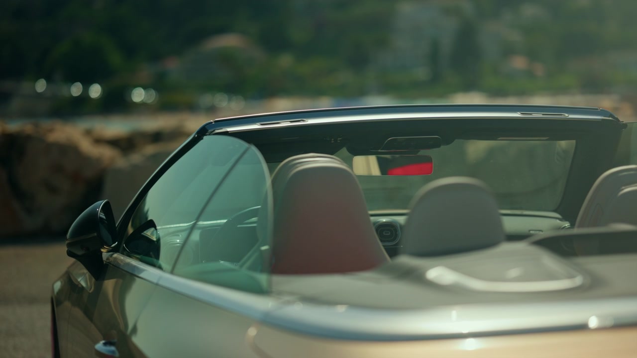 Close up detail of a luxury convertible interior and windshield, highlighting modern design, premium craftsmanship