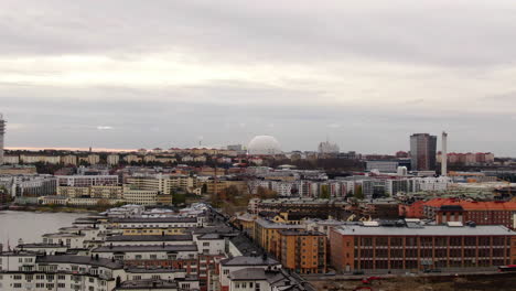 Aerial-over-Stockholm-river-pushing-in-towards-southern-skyline