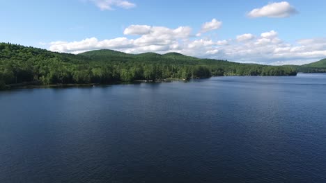 aerial drone shot flying over loon lake towards pregnant lady mountain formation in the adirondacknew york, mountains in new york on a sunny summer day