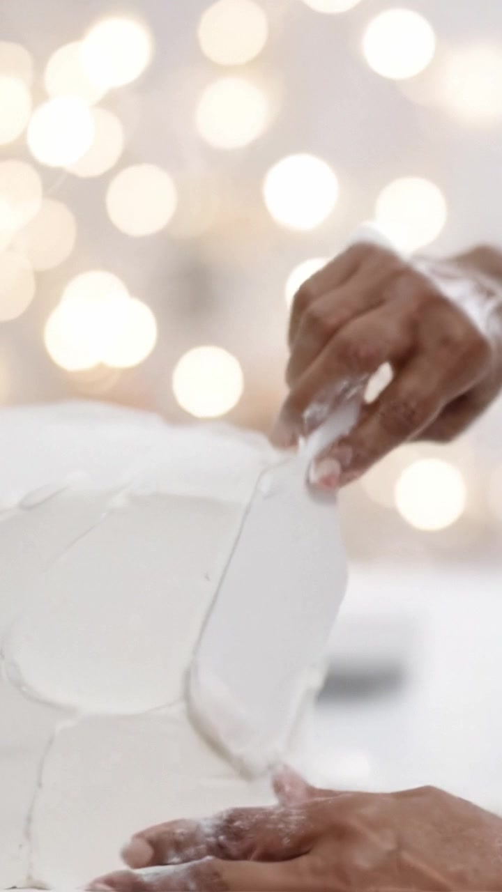 Delicate Hands Skillfully Frosting a White Cake in a Bright, Softly Lit Environment with Bokeh Background Creating an Elegant Culinary Atmosphere