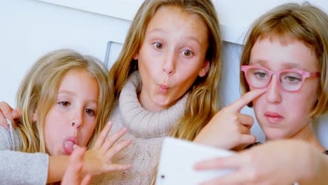 siblings taking selfie with mobile phone in bedroom 4k